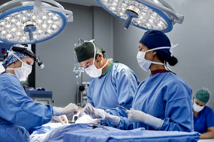 Compact 3D Printer Repairs Vocal Cords During Surgery Female surgeon operating patient at emergency room