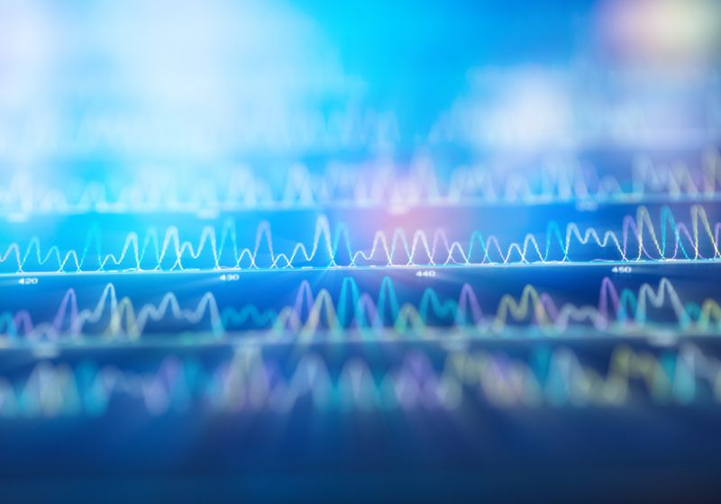 A Comprehensive Guide to Next-Generation Sequencing Image of a woman with her hands across her stomach. She has a look of discomfort on her face. There is a blown up image of her stomach next to her and it has colorful butterflies and gut bacteria all swarming within the gut.