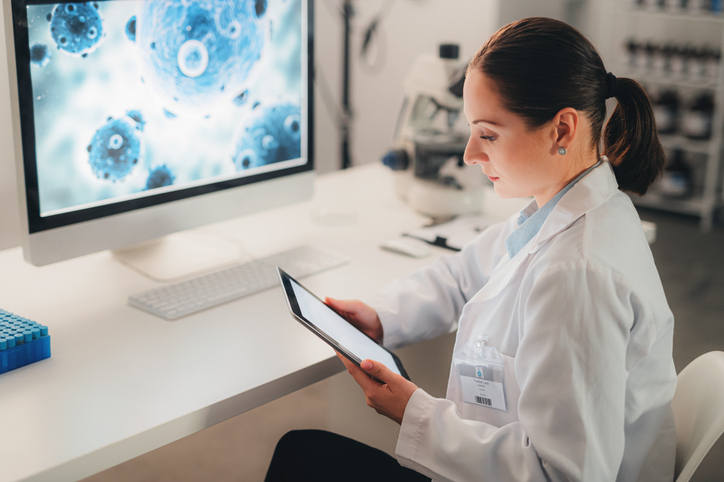 How to Avoid a Fall by Balancing Cost and Performance in Drug Discovery Virus, woman scientist and computer, tablet and laboratory analytics for expert innovation, health planning and app in Poland. Biotechnology analysis online of bacteria, test and digital particles